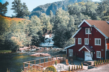 house in norway with waterfall in background