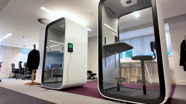 Modern office equipped with soundproof pods ensuring privacy for focused work and phone calls. Low Angle, Push Forward Shot