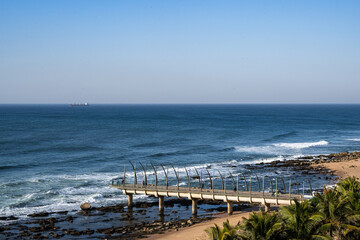 Fototapeta premium Umhlanga Beach with Whalebone Pier in South Africa on blue sky day