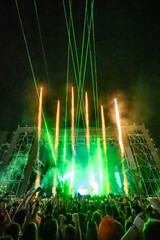 Crowd enjoying spectacular fireworks and laser show at music festival