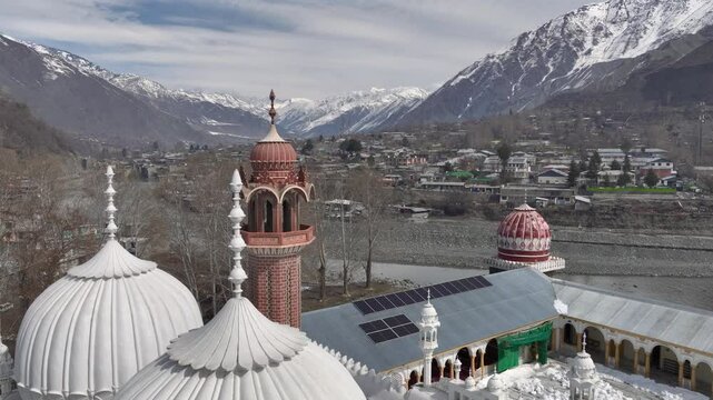 Aerial view of Chitral Central Mosque in Winter in Khyber-Pakhtunkhwa, Chitral, Pakistan. White Domes in sunny day