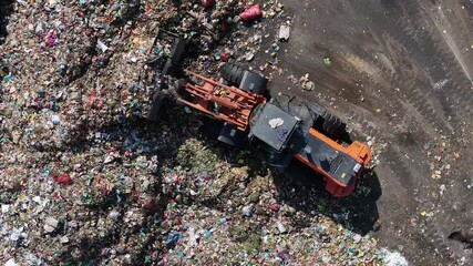 Dhaka, Bangladesh - 01 March 2025: Aerial view of a polluted landfill with bulldozers and waste, Dhaka, Bangladesh.