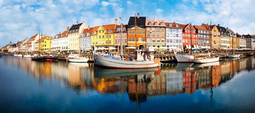 Nyhavn Pedestrian waterfront street: outdoor cafes & colorful buildings. Nyhavn (New Harbour) is XVII century waterfront, canal and entertainment district - Powered by Adobe