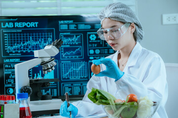 A food scientist conducts research and analysis in a laboratory, focusing on nutrition, safety, and...