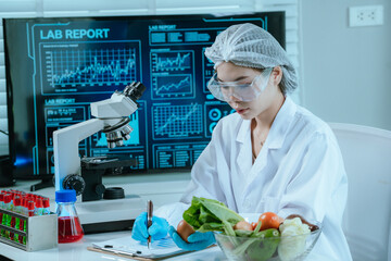 A food scientist conducts research and analysis in a laboratory, focusing on nutrition, safety, and...