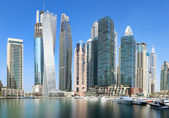 Dubai Marina at day with boat and blue sky, UAE