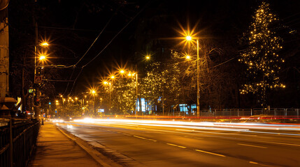 Busy city road night motion blur street lights glowing trees urban traffic speed long exposure fast cars festive atmosphere holiday energy rush hour yellow black background editorial banner copy space