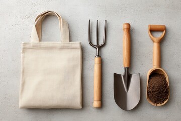 Gardening tools set with beige tote bag on concrete surface.