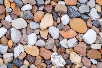 Variety of colorful rounded river stones in natural arrangement.
