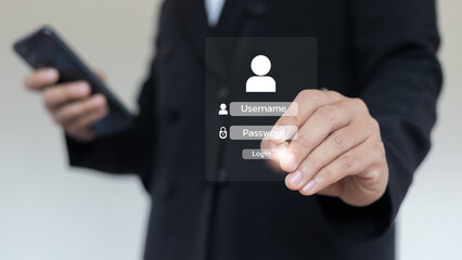 A businessman using a smartphone and virtual screen to enter a username and password for login...