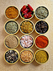 Flatlay of colorful spices in wooden containers – top view kitchen composition