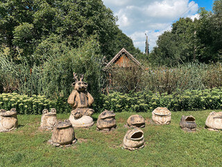 Unique pagan sculptures depicting frogs and mystical figures in Opishnia, Poltava, Ukraine, highlighting local culture and beliefs