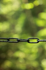 Chain link fence with a chain hanging down