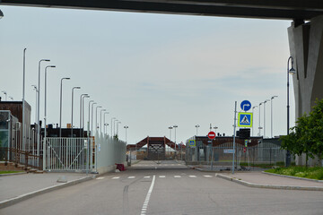View of the industrial area entrance under the bridge, highlighting the urban landscape