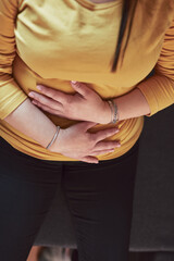Woman with strong stomach ache, menstrual and digestive issues at home.