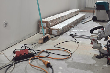Assembling new laminate hardwood floor.