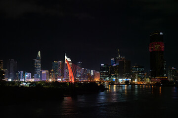 Fototapeta premium Saigon river and the Ho Chi Minh City skyline at night, Vietnam
