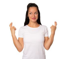 Young brunette woman in white t-shirt praying for luck with crossed arms and looking side over transparent background. PNG