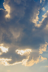 Landscape with the sun hidden behind the clouds on a summer day