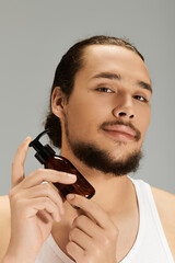 Handsome young man applying grooming product with confidence during a modern styling session