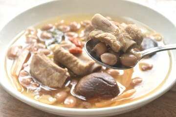 boiled chop pork bone with peanut and black mushroom soup on plate
