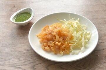 boiled jellyfish with slice cabbage on plate dipping Thai spicy and sour seafood sauce