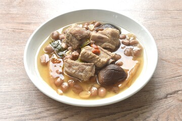 boiled chop pork bone with peanut and black mushroom soup on plate