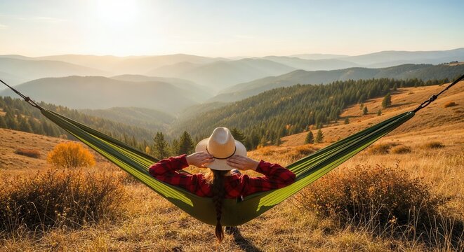 Woman relaxing in hammock overlooking scenic mountain landscape during sunny autumn afternoon, peaceful outdoor nature retreat. - Powered by Adobe
