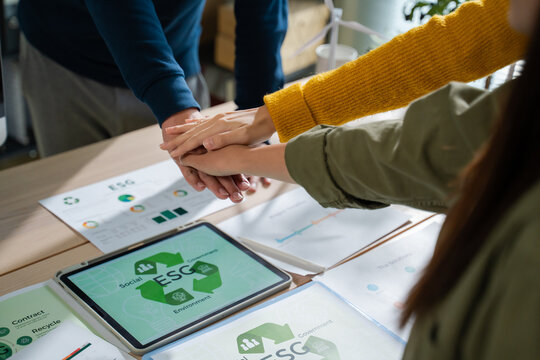 Asian business team discussion reusable product in office,start up eco-friendly business,environmental protection,sustainable business model,ESG strategy,team meeting,people work at home concept