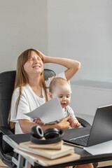 Frustrated girl with baby during remote work. Copy space