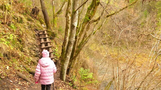 Little beautiful girl walks in Slovak Paradise. Slovak Paradise (Slovensky raj) is mountain range in eastern Slovakia, part of Spis-Gemer Karst, located between towns of Spisska Nova Ves and Dobsina.