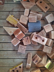 Background with wooden cubes. Chaotically scattered wooden figures. Wooden toys for educational games for children.