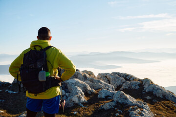 An extreme mountaineer, equipped with professional gear, pushes towards the peak of the mountain at...