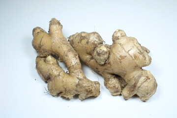 Raw ginger roots, with distinctive knobby and earthy appearance isolated on a clean white...
