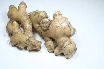 Raw ginger roots, with distinctive knobby and earthy appearance isolated on a clean white...