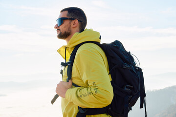 An extreme mountaineer, equipped with professional gear, pushes towards the peak of the mountain at...