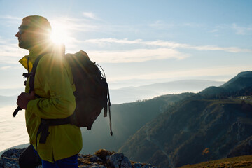 An extreme mountaineer, equipped with professional gear, pushes towards the peak of the mountain at...