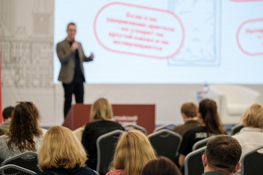 Conference presentation focused on engaging audience as speaker delivers talk with visuals on screen