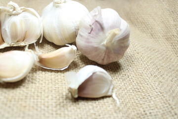 garlic bulbs arranged on a textured burlap background perfect for culinary and natural themes
