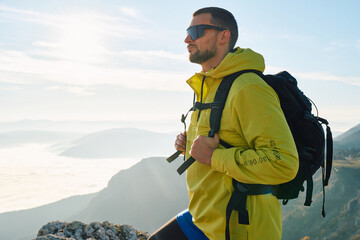 An extreme mountaineer, equipped with professional gear, pushes towards the peak of the mountain at...