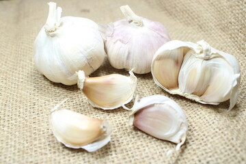 garlic bulbs arranged on a textured burlap background perfect for culinary and natural themes