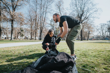 Two people collaborate in a park as they prepare equipment for an outdoor activity.