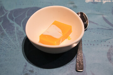 March 27 2025 Mango Pudding Dessert with Cream on Elegant Blue Table Mat