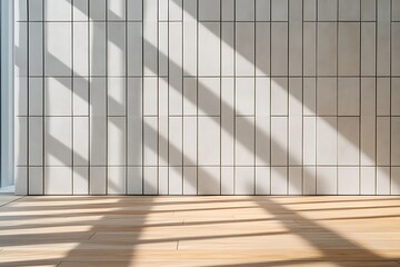 Obraz premium Modern interior with white tiled wall, wood floor, and sunlight creating shadows