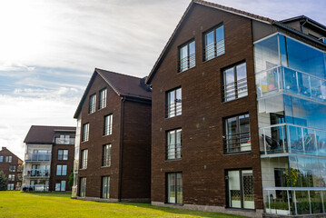 Modern apartment building with large glass windows and balconies.