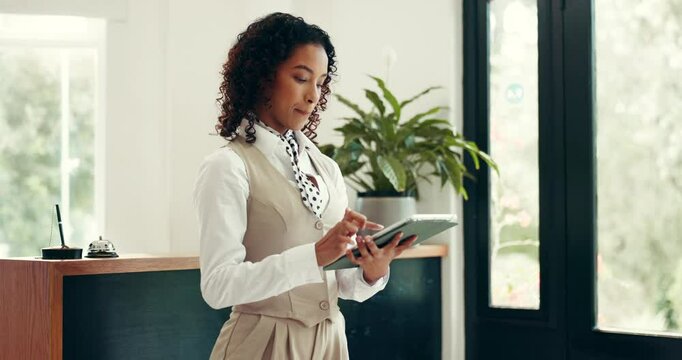 Receptionist, hotel and woman with tablet in lobby for online booking, check in app and schedule. Hospitality industry, concierge and typing on digital tech at front desk for reservation management