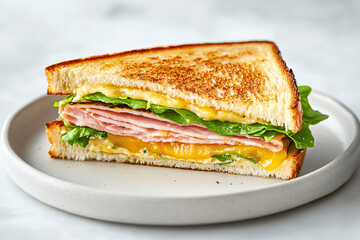Triangular sandwich with ham, cheese, and lettuce on a plate, clean close-up food photography with bright natural lighting