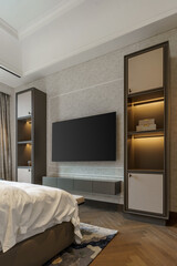 Elegant bedroom entertainment center with a wall-mounted TV and illuminated built-in shelves. A harmonious blend of modern and classic design elements.