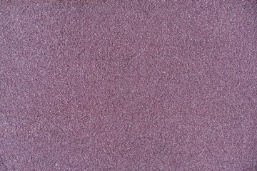 Macro view of a rough purple textured surface. Granular and speckled background, similar to...