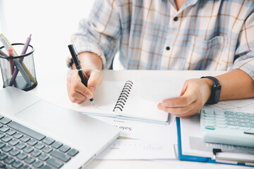 Woman calculating monthly home expenses, taxes, bank account balance and credit card bills payment,...